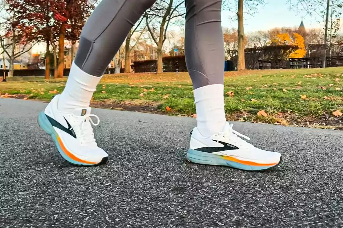 A person walks outside while wearing the Brooks Men's Trace 3 Road Running Shoes