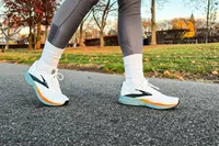 A person walks outside while wearing the Brooks Men's Trace 3 Road Running Shoes