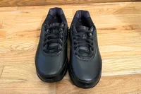 A pair of Women's Addiction Walker 2 Sneakers on a wooden floor