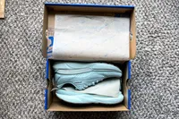 A pair of Brooks Women's Adrenaline GTS 24 Running Shoes in a shoebox with tissue paper