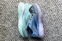 The Brooks Women's Adrenaline GTS 24 Running Shoe next to a different Brooks sneaker