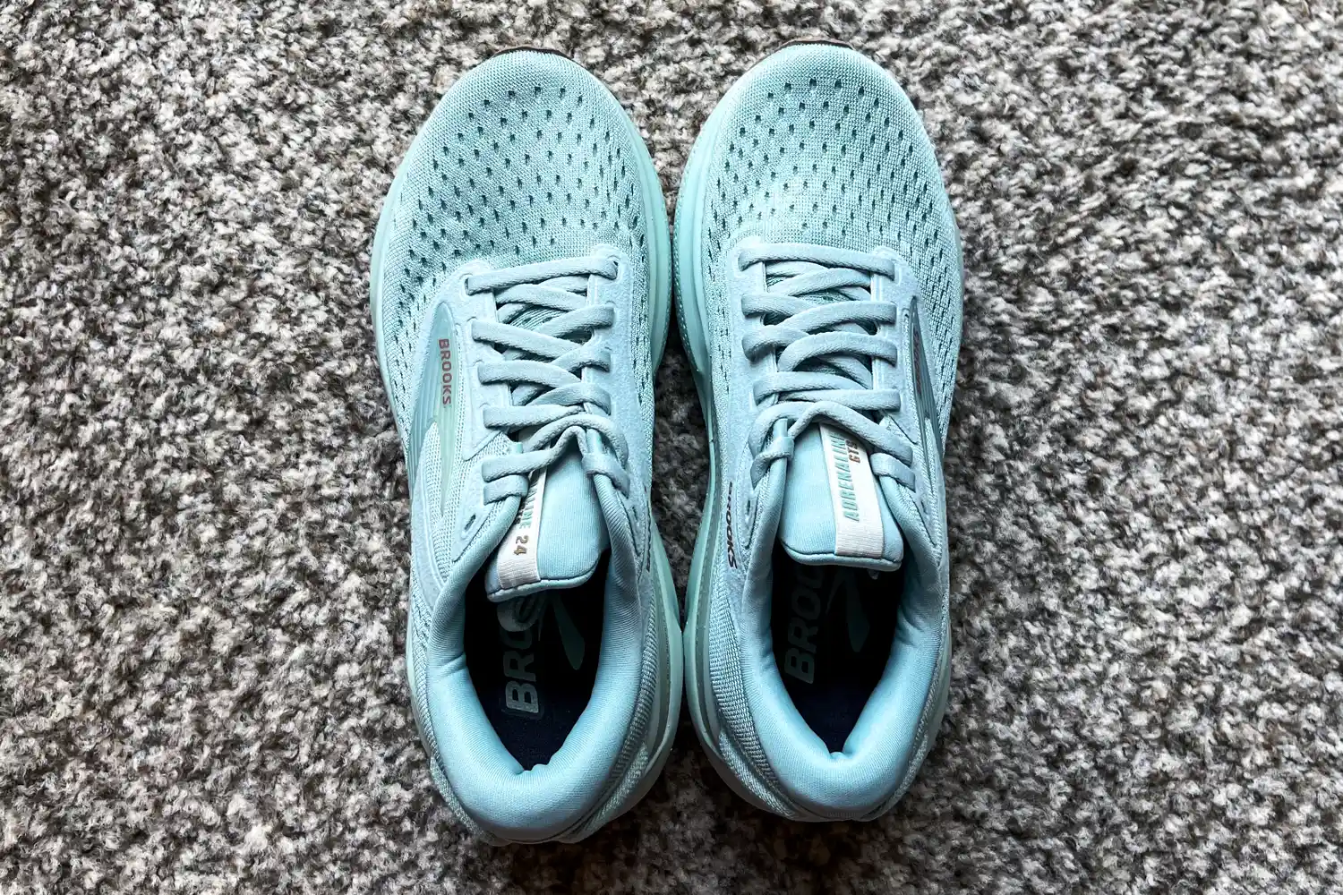 A pair of Brooks Women's Adrenaline GTS 24 Running Shoes on a carpeted floor