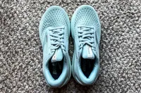 A pair of Brooks Women's Adrenaline GTS 24 Running Shoes on a carpeted floor