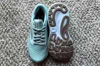 A pair of Brooks Women's Adrenaline GTS 24 Running Shoes on carpet