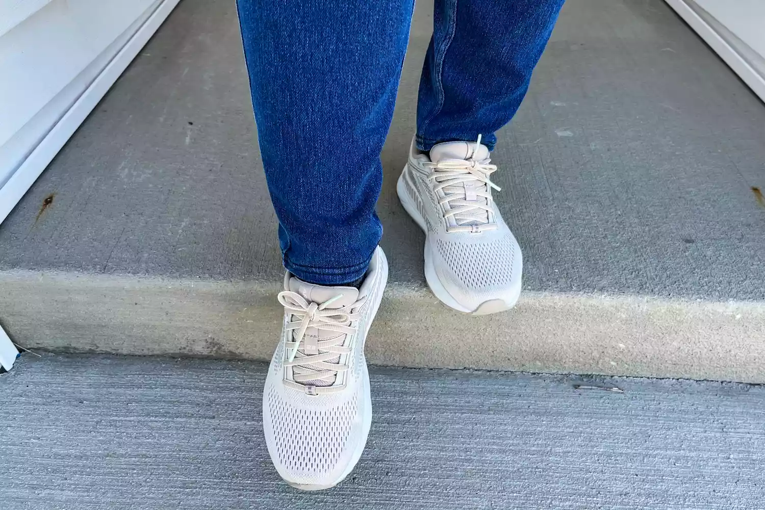 A person wears the Brooks Women's Ariel GTS 23 Running Shoes while walking outside