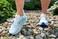 A person walking over stones wearing Brooks Women's Glycerin GTS 22 Running Shoes