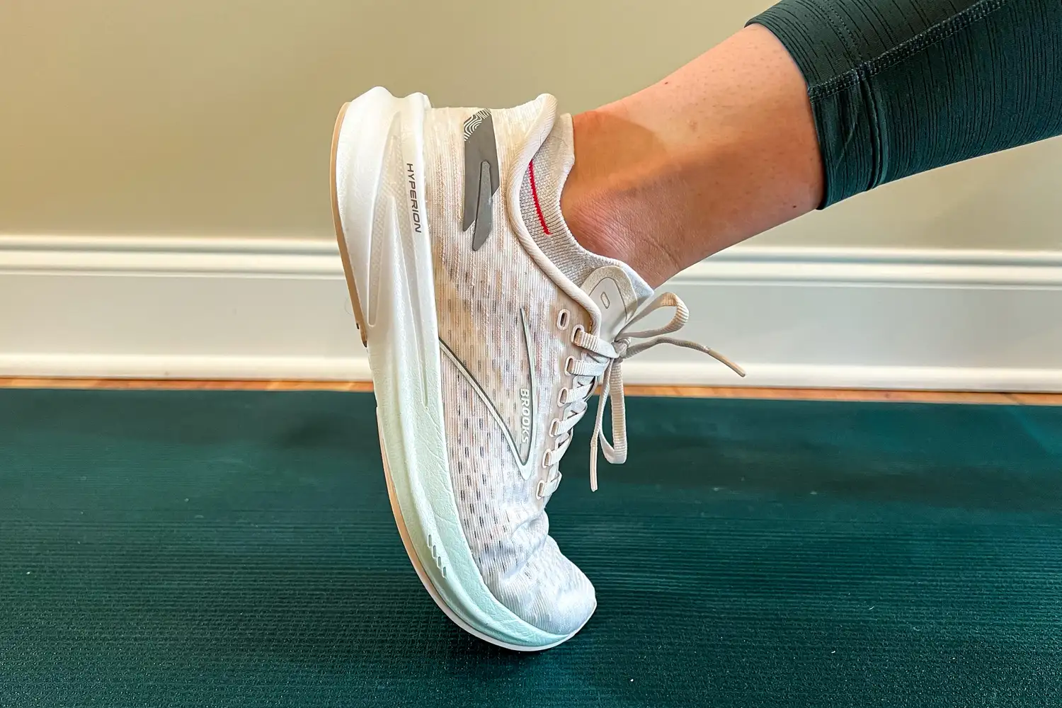 Close-up of a person's foot in a running shoe raised onto the tip-toe position