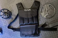 The CAP Barbell 20-150 Lb Adjustable Weighted Vest on a gym floor