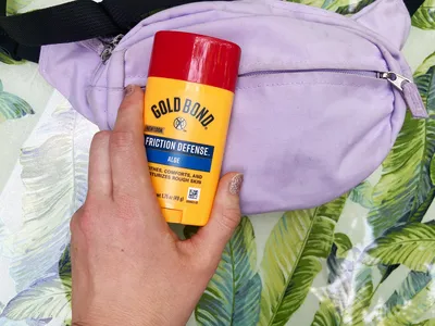 A person holds the Gold Bond Friction Defense Moisturizing Stick