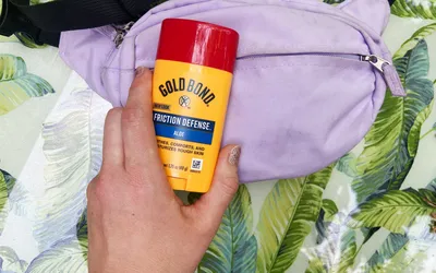 A person holds the Gold Bond Friction Defense Moisturizing Stick