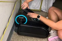 A person touches the pedal on the Cubii Move Under Desk Elliptical Bike