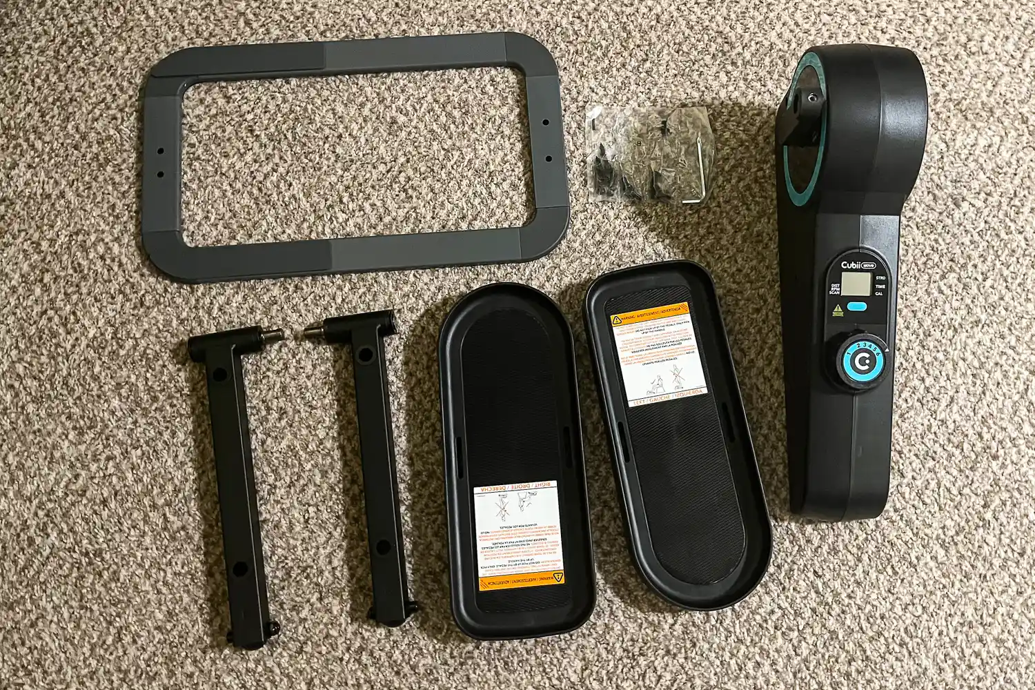 The parts of the Cubii Move Under Desk Elliptical Bike before assembly