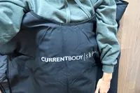 A close-up of a person using the CurrentBody Skin Infrared Sauna Blanket