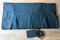 The CurrentBody Skin Infrared Sauna Blanket on a wooden floor