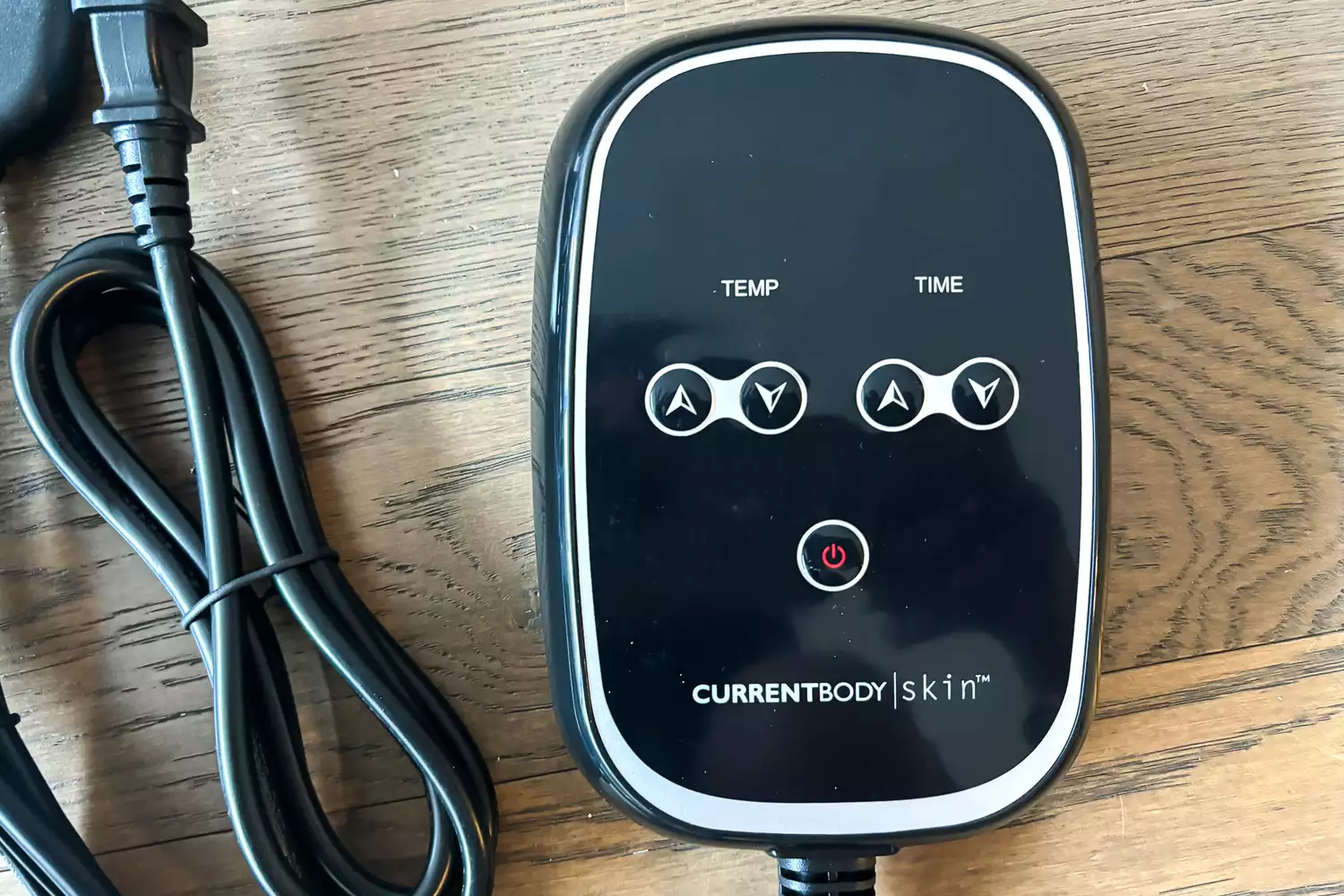 A close-up of the remote of the CurrentBody Skin Infrared Sauna Blanket