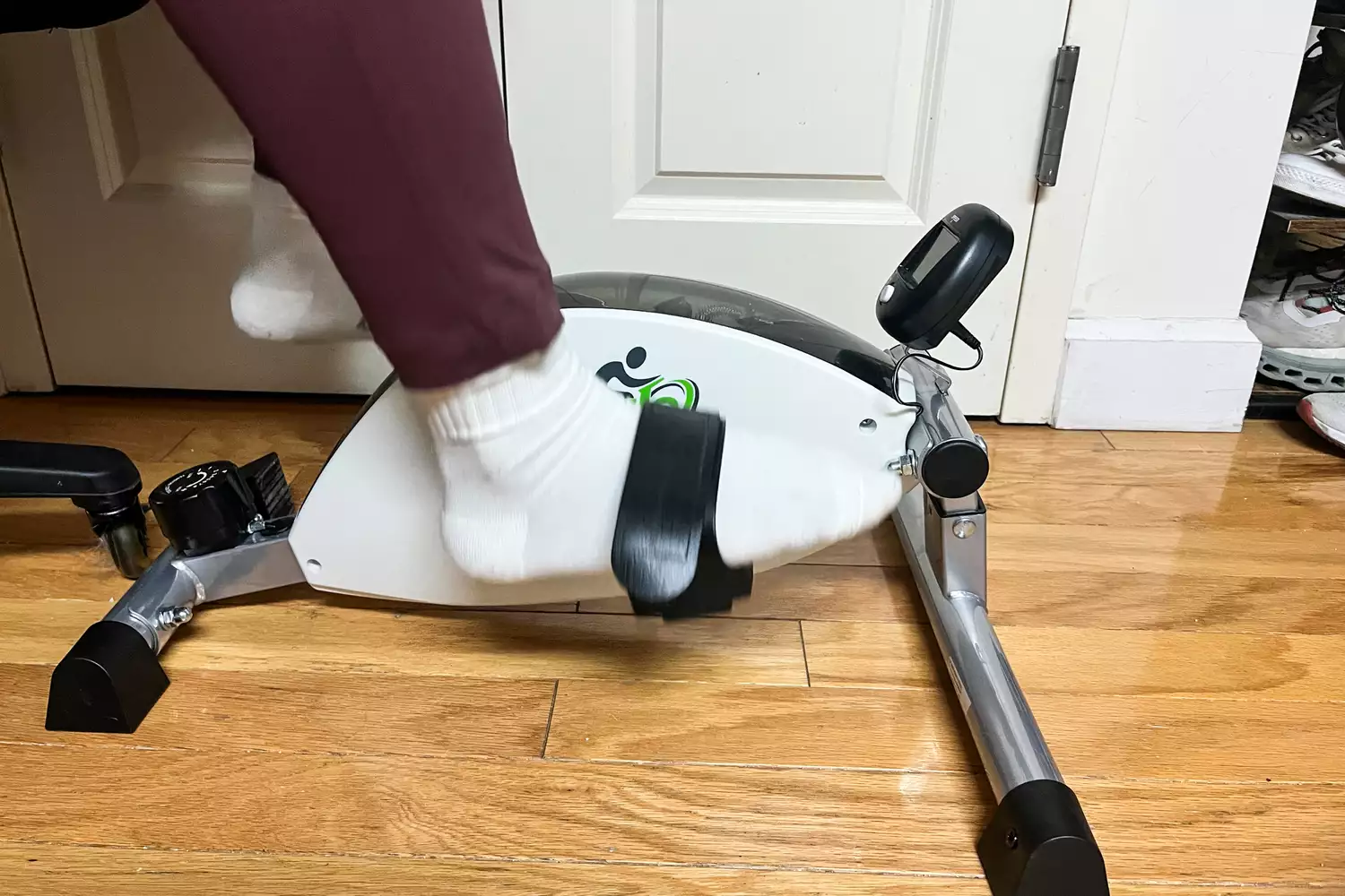 A person uses the DeskCycle 2 Under Desk Bike Pedal Exerciser