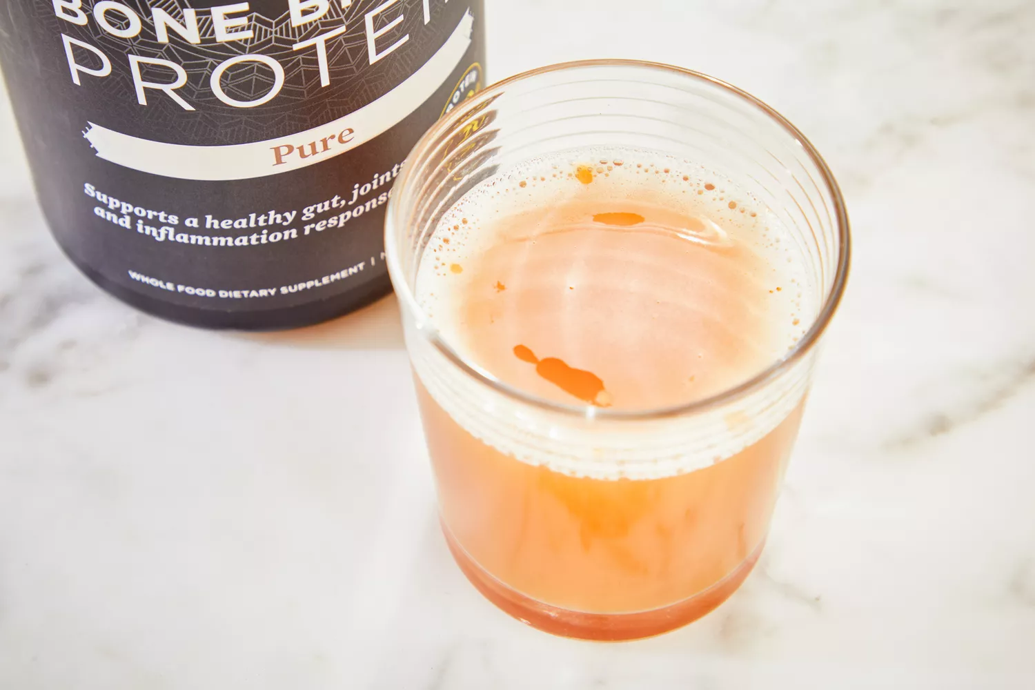 A glass of Ancient Nutrition Bone Broth Protein