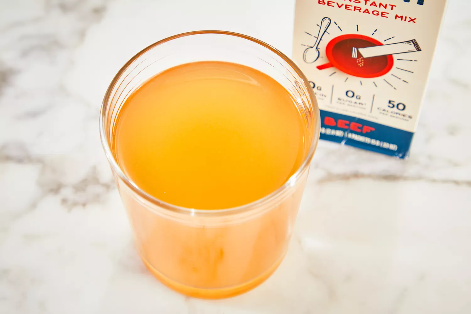 A glass of Bare Bones Bone Broth Instant Powdered Beverage Mix