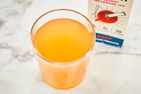 A glass of Bare Bones Bone Broth Instant Powdered Beverage Mix