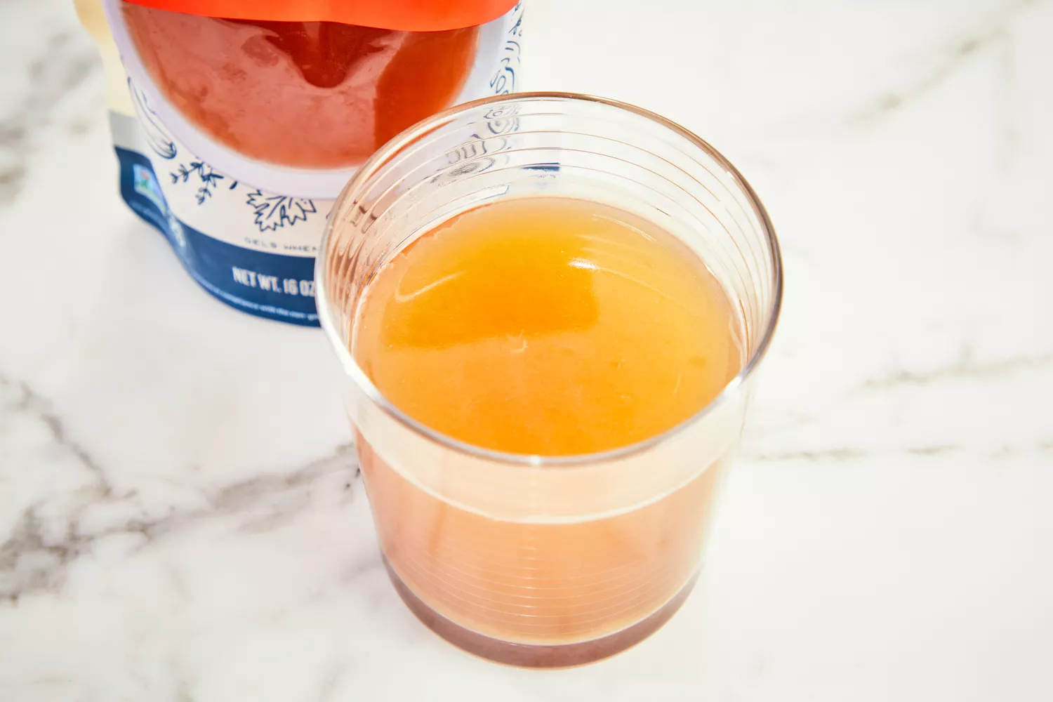 A glass of Bare Bones Grass-Fed Beef Organic Bone Broth