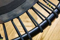 The straps of the bellicon 39 Inch Mini Trampoline up-close above a wooden floor