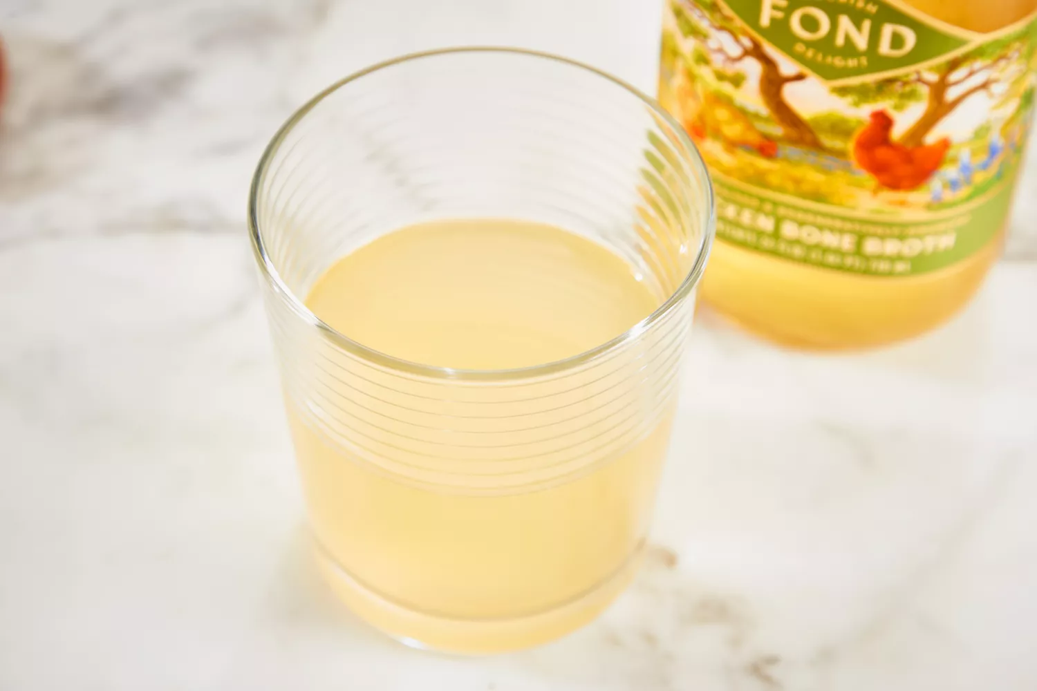 A glass of FOND Certified Organic Chicken Bone Broth