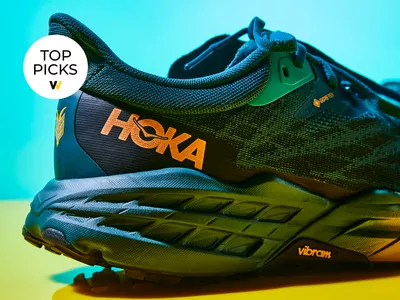 Hoka gortex shoes on blue and yellow backdrop