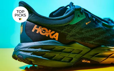 Hoka gortex shoes on blue and yellow backdrop