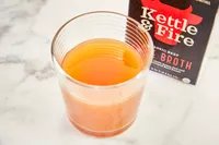 A glass of Kettle & Fire Bone Broth