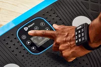 Hand presses buttons on the LifePro Rumblex Plus 4D Vibration Plate Exercise Machine