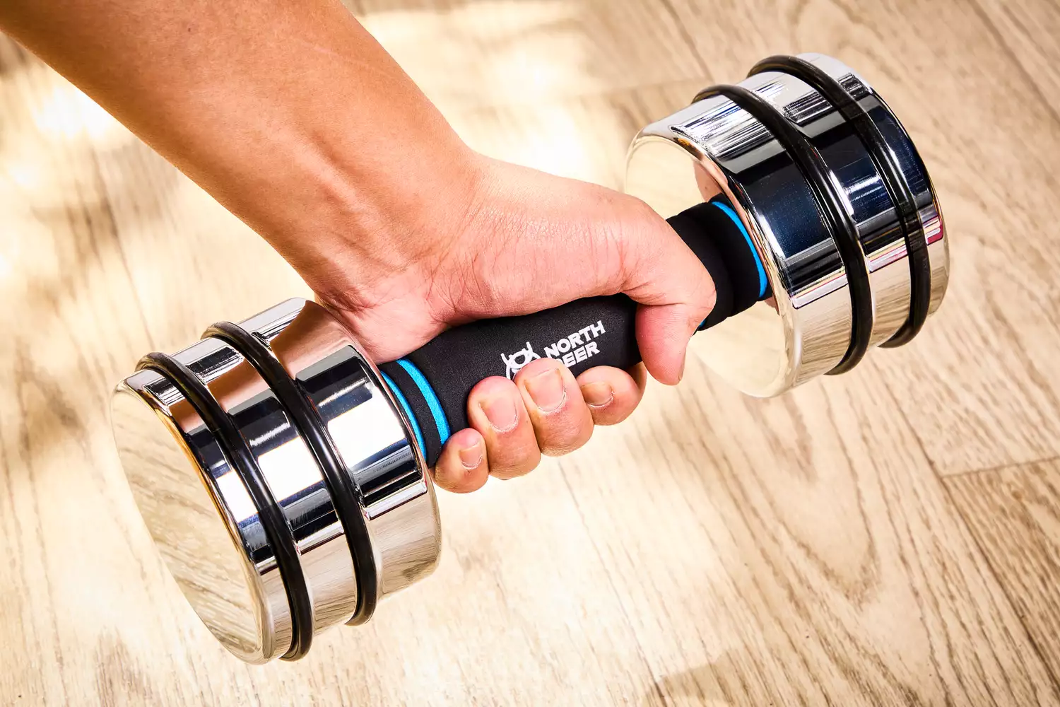 A person lifts the Northdeer Steel Dumbbells Ultracompact & Adjustable Chrome Dumbbell