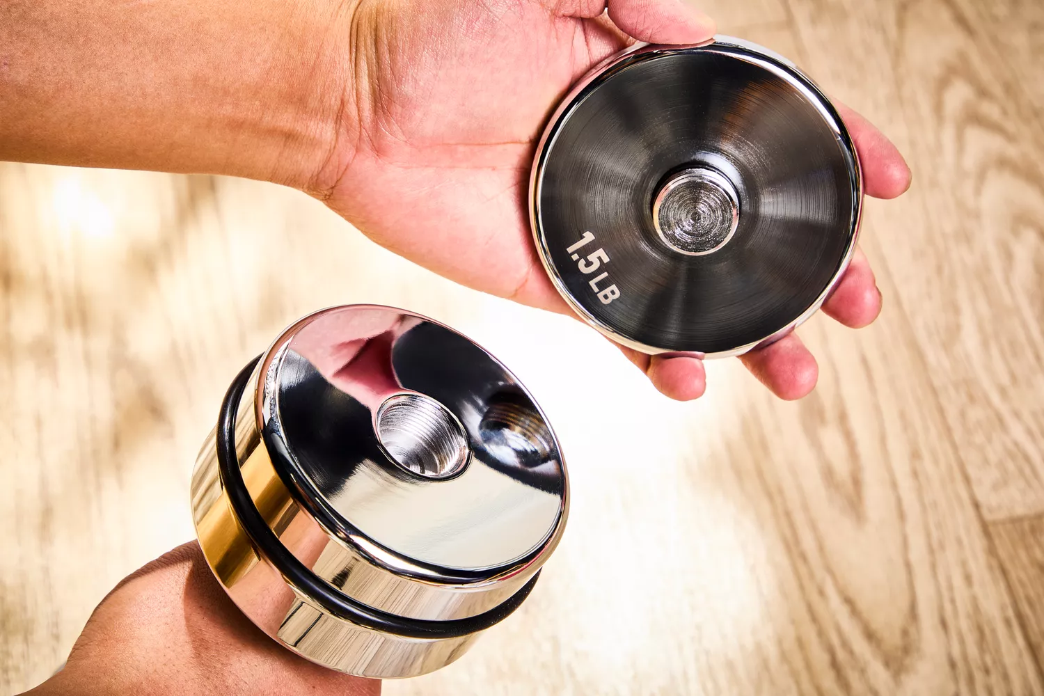 A person assembles the Northdeer Steel Dumbbells Ultracompact & Adjustable Chrome Dumbbell