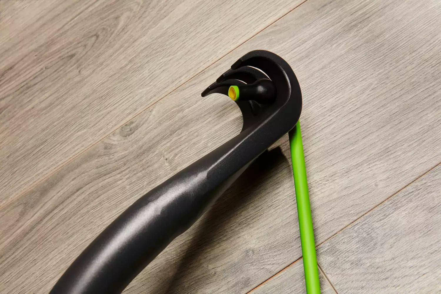 Closeup of one resistance band hooked onto the bar of the Gorilla Bow The Original Total Bundle