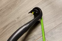 Closeup of one resistance band hooked onto the bar of the Gorilla Bow The Original Total Bundle