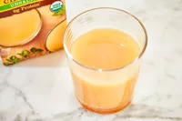 A glass of Pacific Foods Chicken Bone Broth on countertop