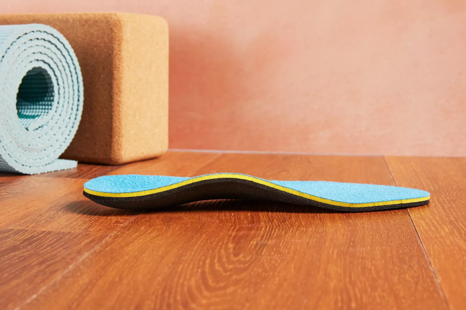 Redi-Thotics Flex Orthotic Insole displayed on a wood floor