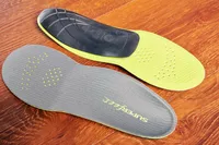 Top and bottom of Superfeet Run Support Low Arch Shoe Inserts displayed on a wood surface