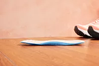 Vionic Slimfit Orthotic Insole displayed on a wood floor