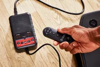 A hand presses a button on the VT Vibration Therapeutic Frequency Vibration Plate