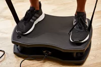 Feet stand on the VT Vibration Therapeutic Frequency Vibration Plate
