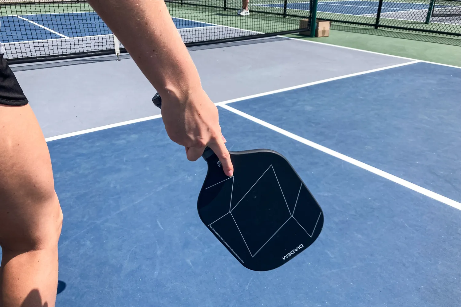 A person holds the Diadem A52 Pickleball Paddle