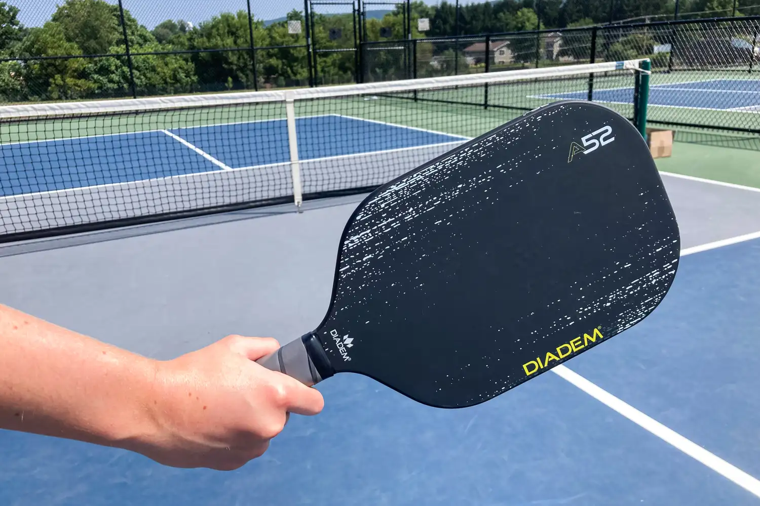 A person holds the Diadem A52 Pickleball Paddle