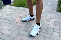 A person wears the Diadem Court Burst Pickleball Shoes on brick
