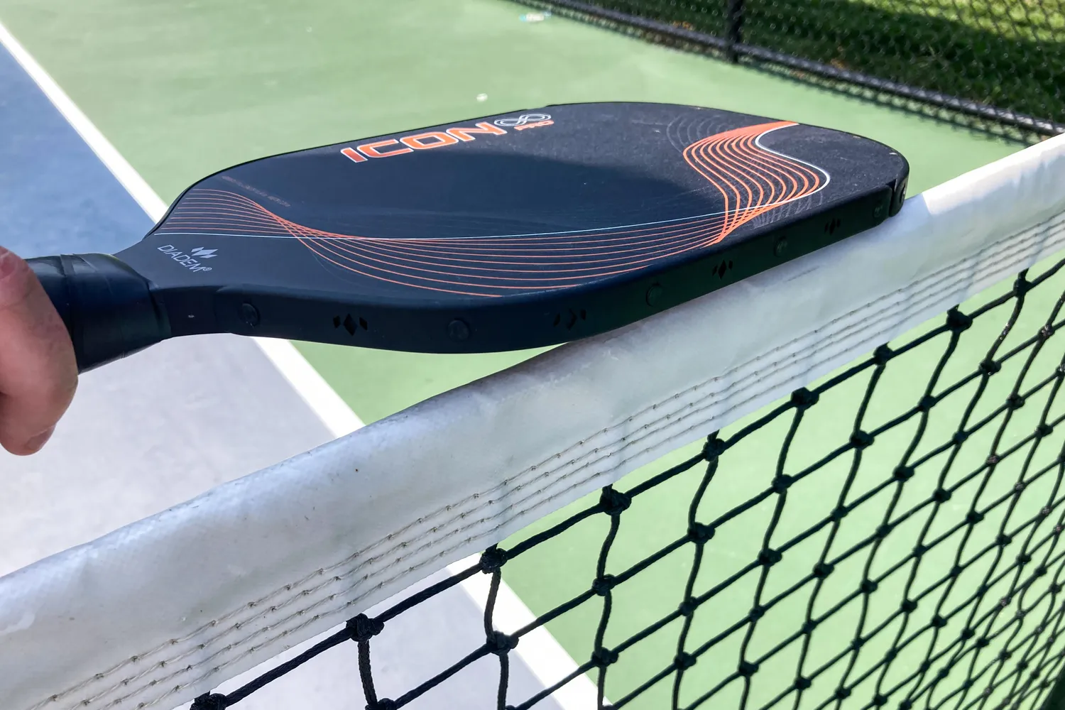 A person holds the Diadem Icon Infinity Pro Pickleball Paddle