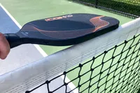 A person holds the Diadem Icon Infinity Pro Pickleball Paddle