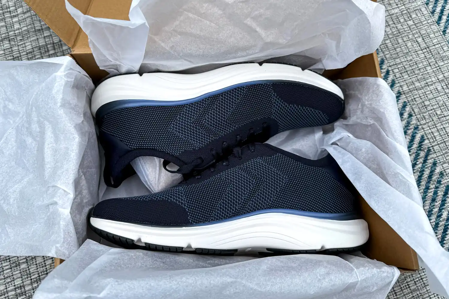 A pair of Dr. Scholl's Men's Feel Ready Lace Up Sneakers in a shoebox lined with tissue paper