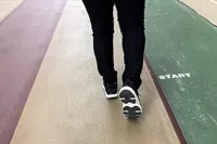 A close-up of a back of a person walking in the Dr. Scholl's Women's Feel Support Lace Up Sneaker