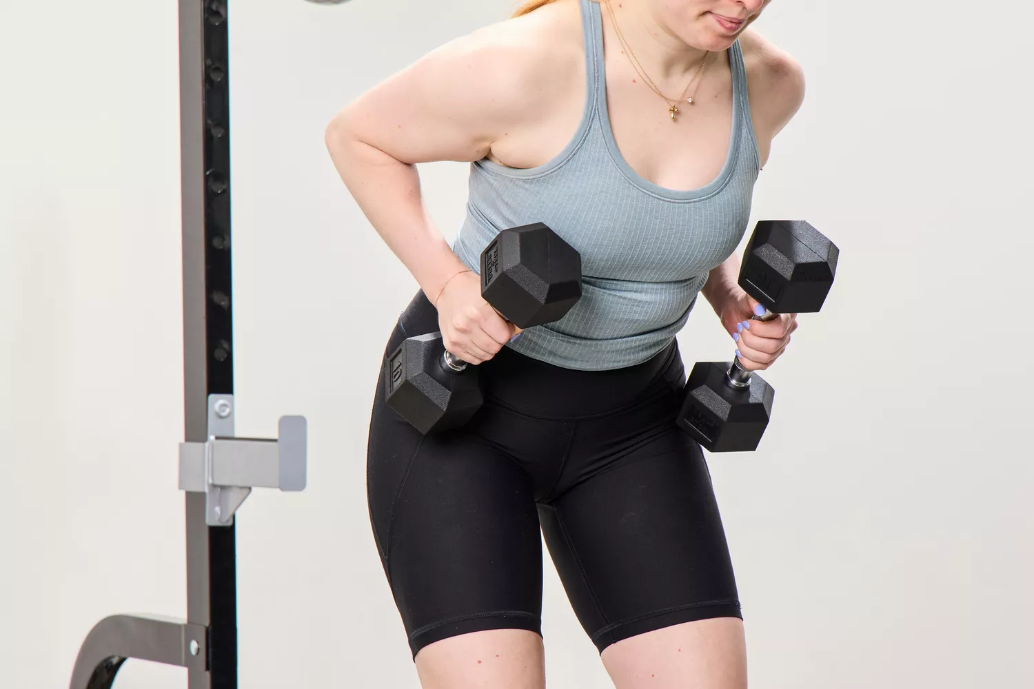 A person lifts the Bells of Steel Ergo Rubber Hex Dumbbells during exercise