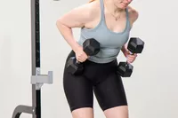 A person lifts the Bells of Steel Ergo Rubber Hex Dumbbells during exercise
