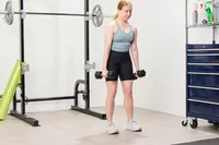 A person uses the Bells of Steel Ergo Rubber Hex Dumbbells to exercise